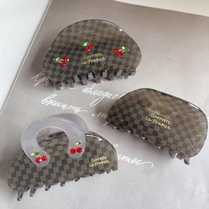 Elegant grey checkered acetate hair claw with cherry crystal detail and gold label accents