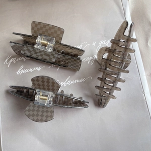 Three-piece acetate checkered hair claw set in translucent brown with gold springs
