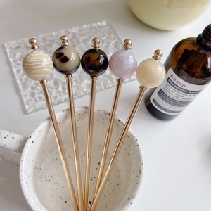 Elegant gold metal hair sticks with acetate spheres in tortoiseshell and cream finishes