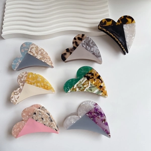 Elegant heart-shaped acetate hair claw clips set in various marble and leopard patterns