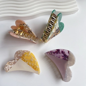 Set of four vintage heart-shaped acetate hair claws in pastel marble and patchwork colors