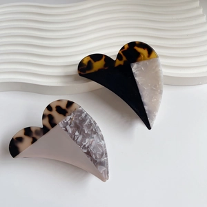 Elegant heart-shaped acetate claw clips with vintage tortoiseshell and marble patchwork design