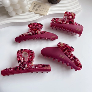 Set of four France acetate hair claws with pink floral splicing and gold lettering