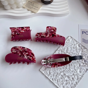 Elegant red acetate hair claw set with floral patterns and gold Barrette la France text