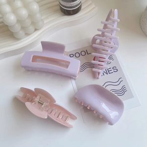 Pink and purple acetate hair claws in rectangle and crescent shapes with metal spring