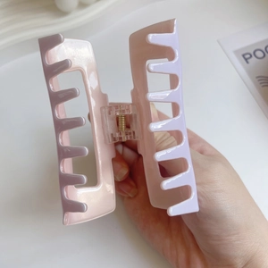 Pink and purple acetate hair claw clip with a hollow rectangular design for women