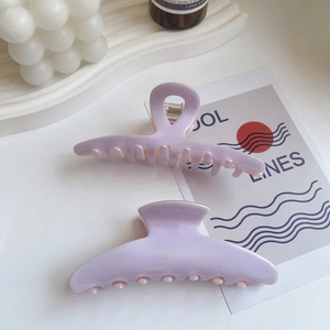 Detail of lavender acetate hair claws with glossy finish and durable metal spring