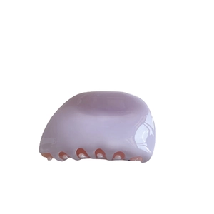 Elegant lavender acetate shark hair claw with white pearls on a clean white background