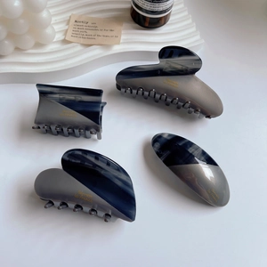 Elegant 4-piece grey acetate hair claw set with blue marble texture and gold lettering