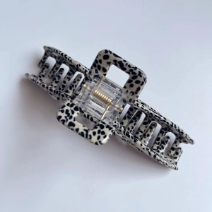 Detail view of the black and white leopard print rectangular claw clip with internal spring