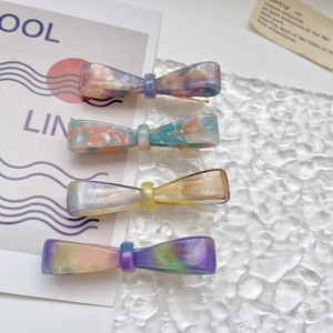 Set of four colorful acetate bow hair clips with elegant marble patterns for women
