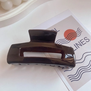 Minimalist French style brown acetate hair claw clip with glossy finish for women