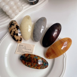 Close-up of assorted tortoiseshell acetate barrettes with France Handmade gold engraving