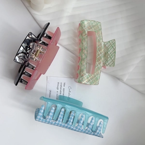 Pink and green contrast hair claw clips in marble and checkered patterns for women