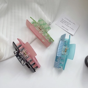 Detailed set of three colorful acrylic claw clips with pink green and checkerboard patterns