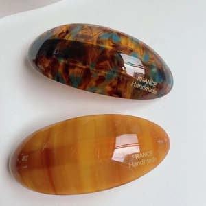 Acetate hair clips set with blue-brown marble and amber striped patterns