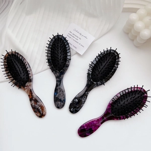 Set of four anti-static marble pattern air cushion hairbrushes in elegant minimalist style