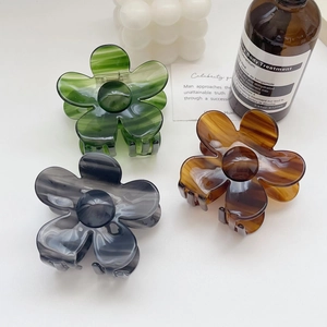 Three acetate flower hair claws in green, amber, and grey with marble texture in ins style