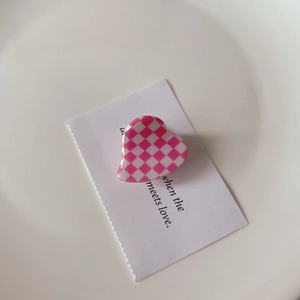 Pink checkered heart hair claw clip in acetate finish on white display card