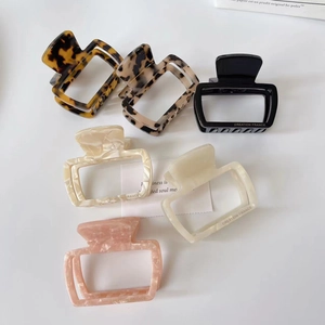 Detail showing various colors of French chic hair claw clips with Creation France text