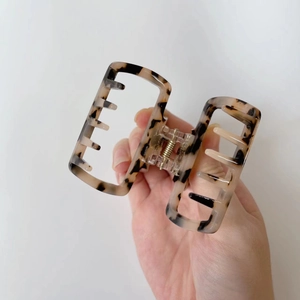 Chic tortoiseshell acetate hair claw clip with marble texture and gold metal spring