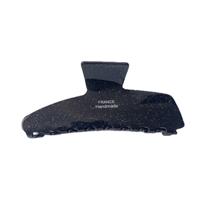 Pince à cheveux en acétate noir avec paillettes dorées et logo France Handmade sur fond blanc