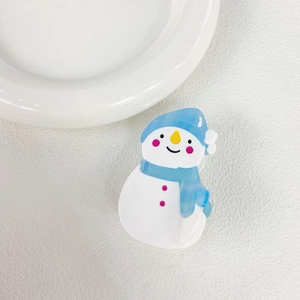 Detailed view of snowman hair claw clip in white and blue acetate for Christmas