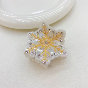 Elegant snowflake hair claw clip with gold outlines and rhinestones on white background