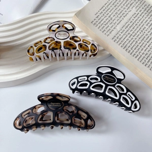 French classic acetate hair claw clips set in monochrome and tortoiseshell hollow design