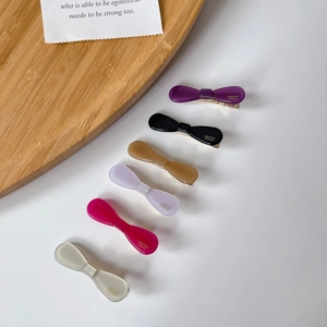 Set of six colorful acetate bow hair clips with gold metal duckbill grips for women
