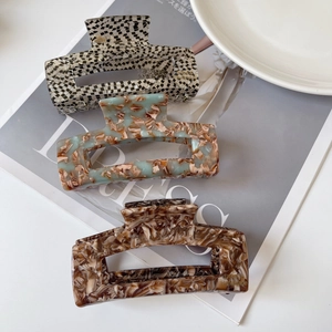 French style acetate hair claws in checkerboard and marble patterns for women's hairstyling