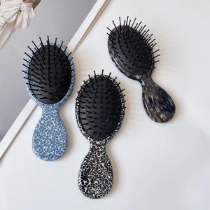 Cute acetate hair brushes with leopard and tortoiseshell patterns on white background