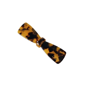 Tortoiseshell acetate bow hair clip with gold logo in a French handmade style