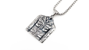 Detailed view of vintage silver military jacket pendant with retro blackened steel texture