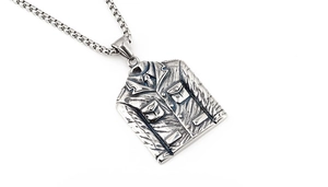 Macro shot of silver suit jacket pendant with intricate lapel and button details