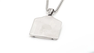 Macro view of polished silver titanium steel geometric pendant with a box chain