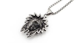Macro detail of vintage silver Indian chief necklace with sunburst textured pendant