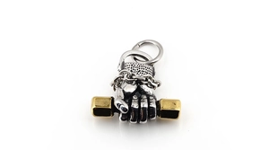 Detail of silver fist holding golden dumbbell pendant in vintage titanium steel style