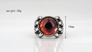 Macro detail of gothic dragon eye ring with red eyeball and silver metal claws