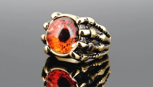 Close-up of gothic dragon claw ring holding a realistic red-orange evil eye stone