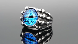 Macro detail of gothic claw ring holding a realistic blue eye with aged metal finish
