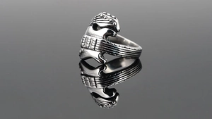 Close-up detail of vintage punk guitar shaped ring in polished titanium steel