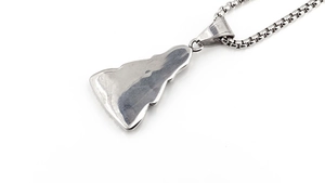 Detailed macro view of a silver box chain and spiritual pendant made of stainless steel