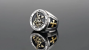 Close-up of St. Michael signet ring with gold relief and vintage steel finish details