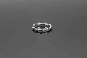 Macro shot of retro bamboo joint titanium steel ring with elegant mirror reflection