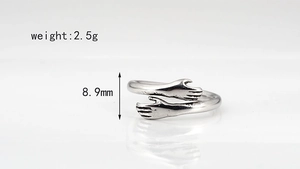 Detail view of silver embrace ring showing 8.9mm width and 2.5g weight specifications