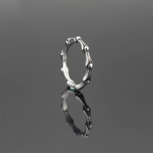 Vintage bamboo style titanium steel ring with silver grey finish on black reflection
