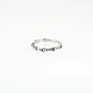 Vintage silver bamboo joint style titanium steel ring with retro punk aesthetic on white background