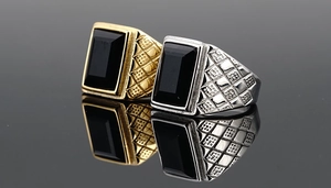 Macro shot of gold and silver men's signet rings with black stone and diamond texture