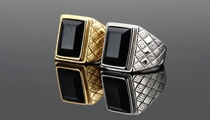 Macro detail of retro gold and silver men rings with rectangular black gemstones and side texture